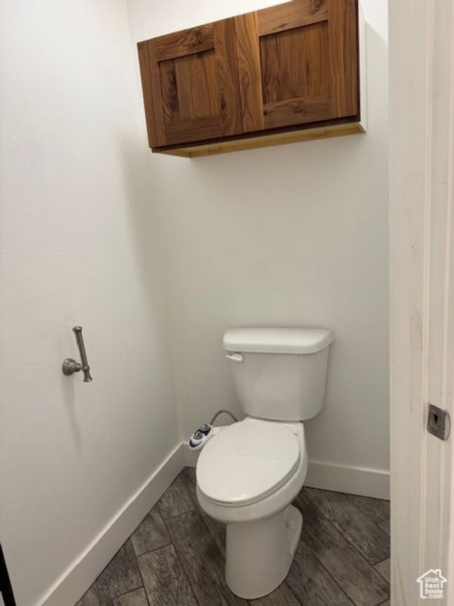 Bathroom featuring wood finished floors, toilet, and baseboards | Image 20