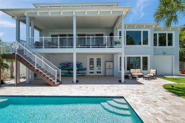 Up close view of the saltwater pool and travertine pool deck offers a great view from the 2nd floor covered balcony or lanai. | Image 9
