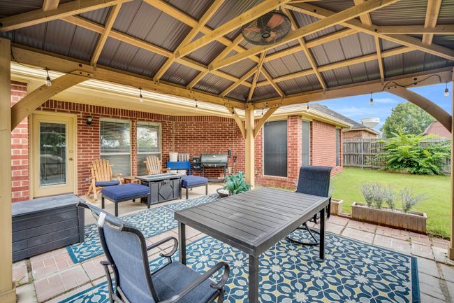 View of patio with a gazebo, grilling area, and outdoor dining space | Image 32