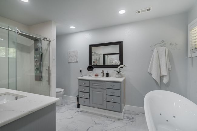 Bathroom featuring vanity, a tub with jets, a stall shower, recessed lighting, and marble finish floors | Image 18