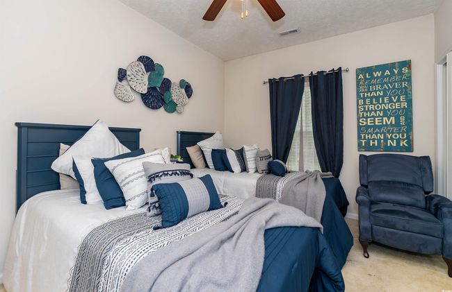 Carpeted bedroom with visible vents, a textured ceiling, and ceiling fan | Image 20