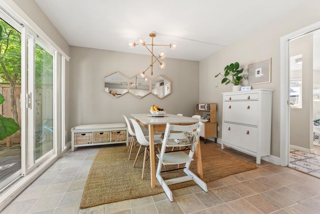 Dining area with a chandelier and baseboards | Image 16