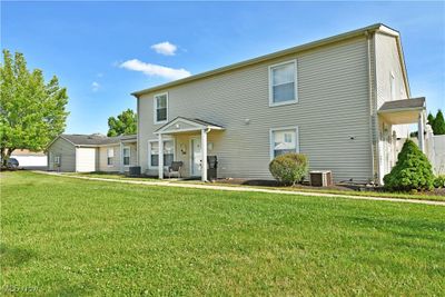 View of front facade with a front yard and central AC unit | Image 3