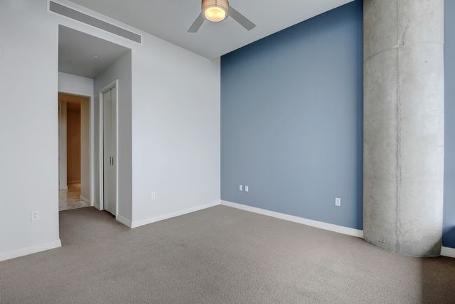 Spare room with a ceiling fan, baseboards, and carpet | Image 11