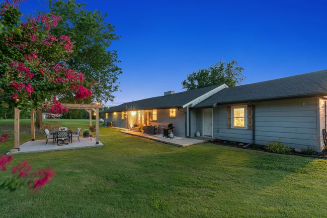 Back of property featuring a patio, a yard, a pergola, and a shingled roof | Image 38
