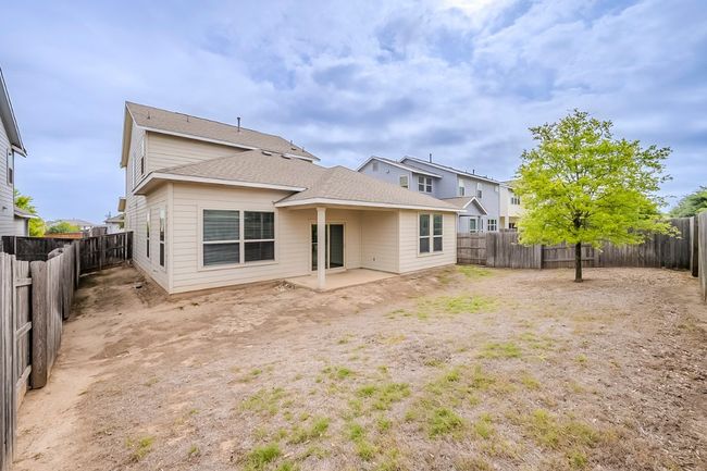 Back of property with a fenced backyard, a patio, and a shingled roof | Image 35