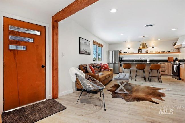 Living area with bar with sink, light wood-style floors, and recessed lighting | Image 25