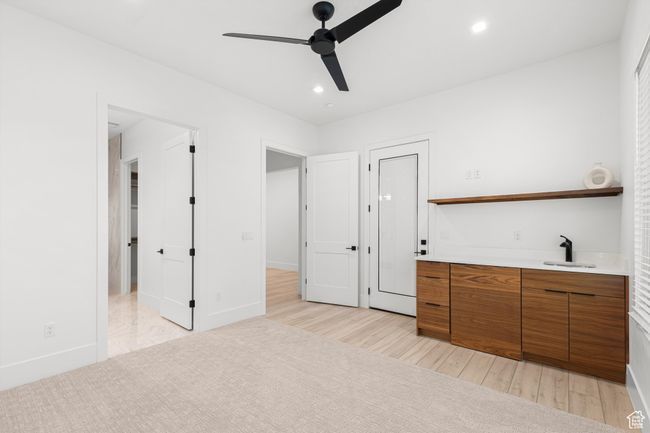 Unfurnished bedroom with indoor wet bar, baseboards, recessed lighting, light wood-style floors, and a sink | Image 20