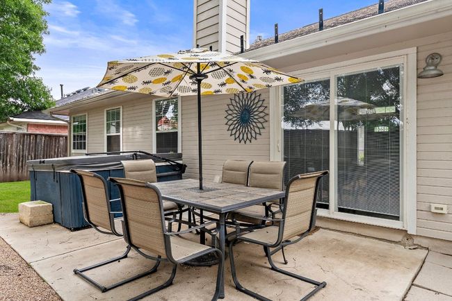 View of patio / terrace with a hot tub and outdoor dining space | Image 23