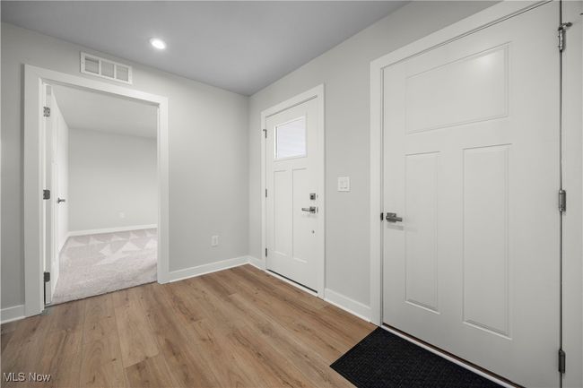 Foyer featuring light wood finished floors, visible vents, and baseboards | Image 4