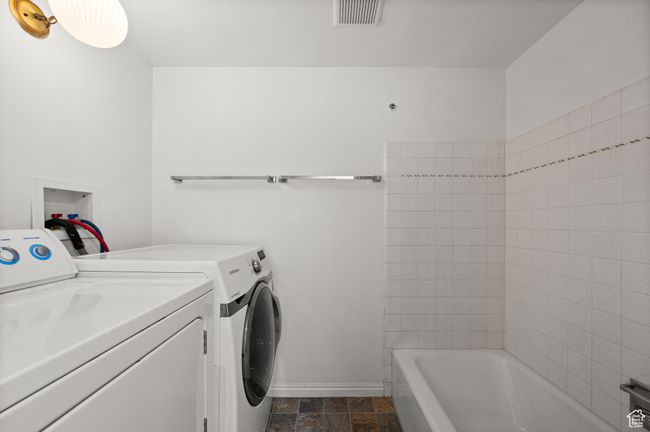 Laundry area featuring washer and dryer and baseboards | Image 17