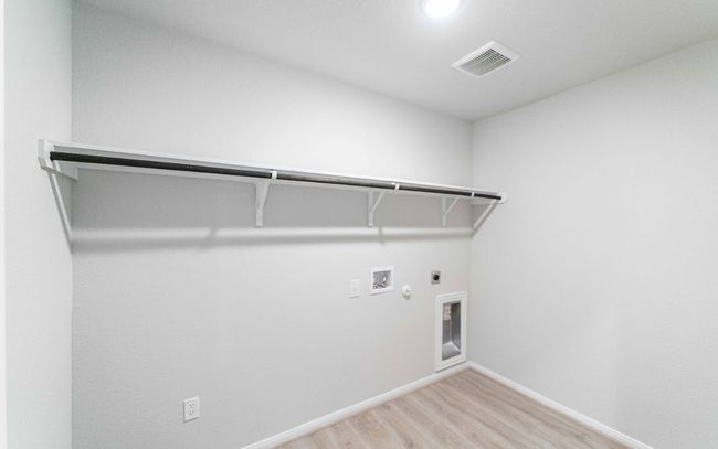 Laundry room with gas dryer hookup, electric dryer hookup, washer hookup, and light wood finished floors | Image 11