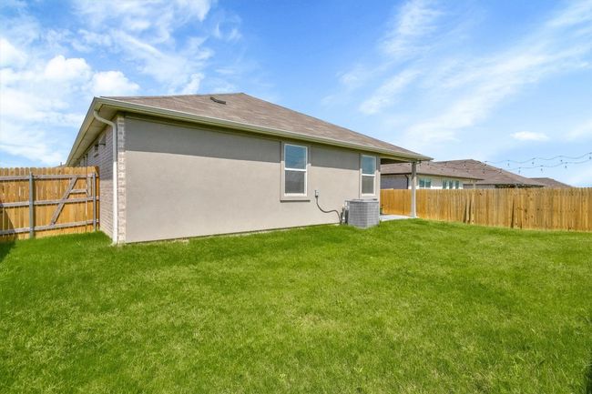Back of house with cooling unit and stucco siding | Image 30
