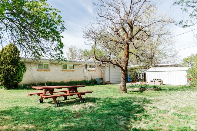 View of yard featuring an outbuilding and central air condition unit | Image 24