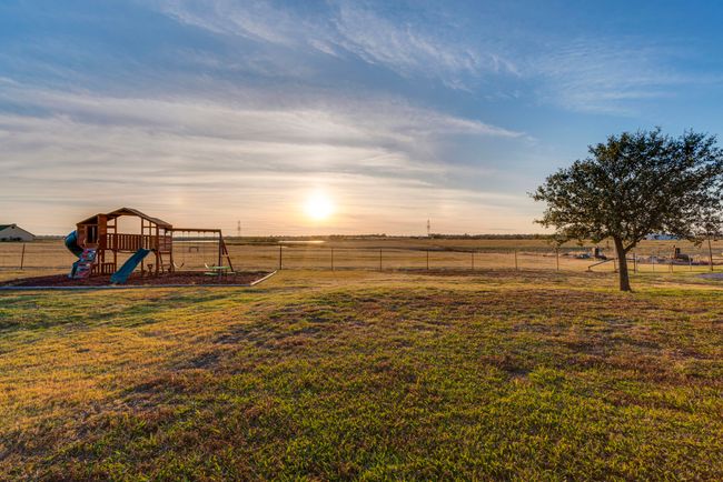 Yard at dusk featuring a playground and a rural view | Image 24