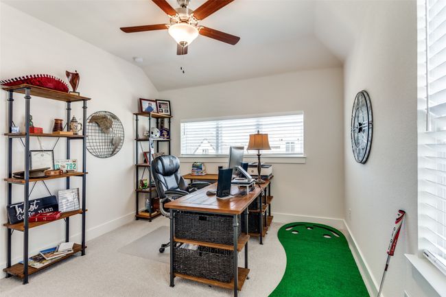 Office space featuring a ceiling fan, carpet flooring, and lofted ceiling | Image 28
