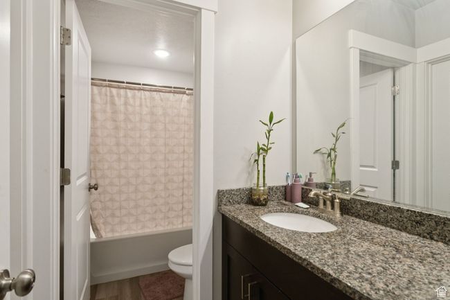 Bathroom featuring vanity and shower / bath combination with curtain | Image 36