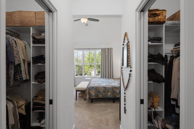 Spacious closet with ceiling fan and carpet floors | Image 24