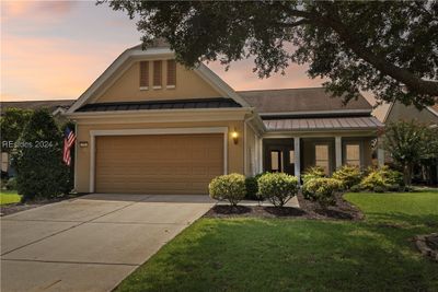 View of front of home featuring a garage and a yard | Image 3