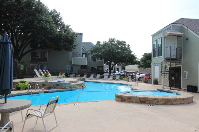 View of pool featuring a pool with connected hot tub, stairway, fence, and a patio area | Image 19