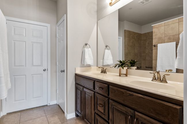 dual sinks and spacious closet | Image 12