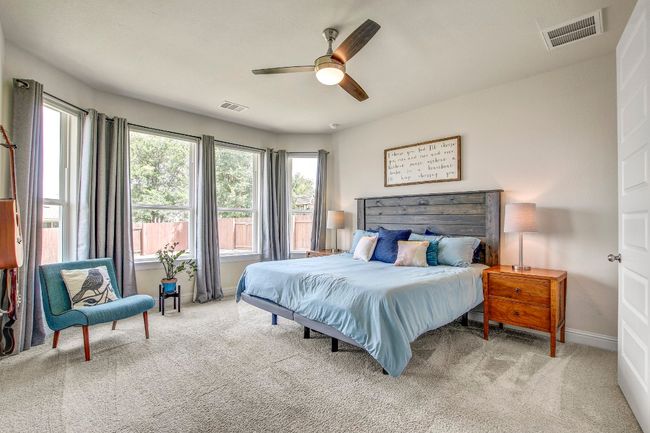 Bedroom with carpet flooring, multiple windows, and ceiling fan | Image 16