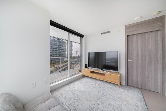 Unfurnished living room featuring floor to ceiling windows | Image 6