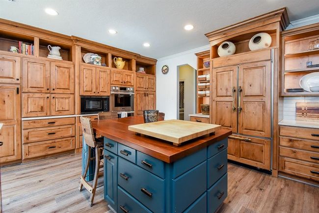 The large kitchen island, magnificent bank of cabinets against the back wall provides pantry and appliance storage. Notice all of the drawers for storage! | Image 17