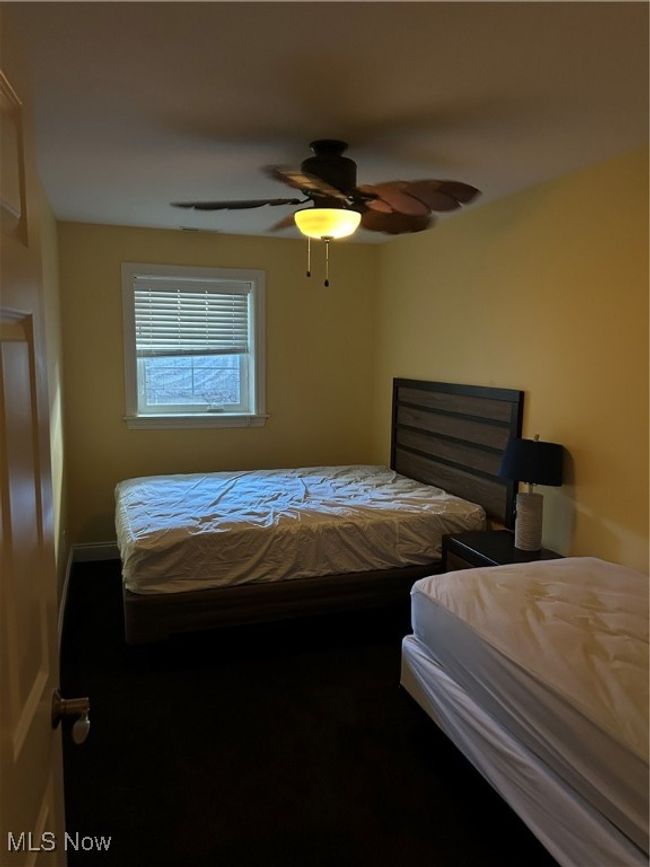 Bedroom featuring ceiling fan | Image 5