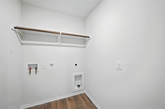Laundry area with electric dryer hookup, hookup for a washing machine, hookup for a gas dryer, and dark wood finished floors | Image 19