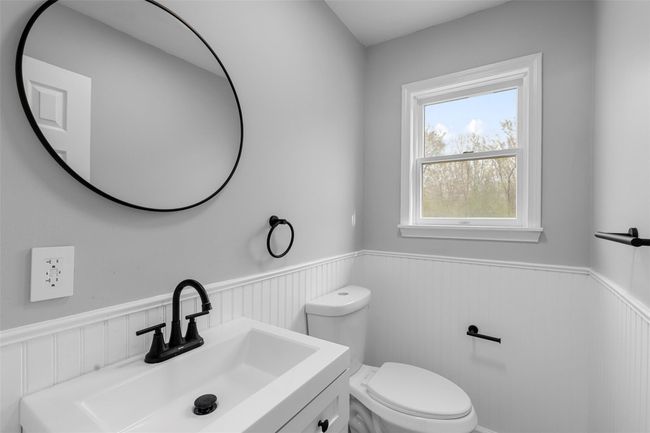Bathroom with wainscoting, toilet, and vanity | Image 14