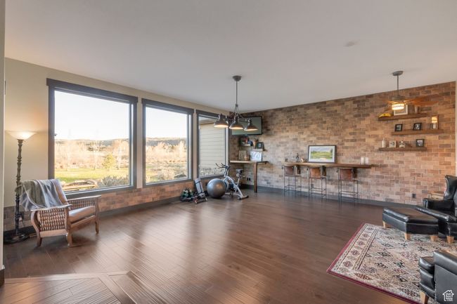 Interior space with brick wall and wood finished floors | Image 16