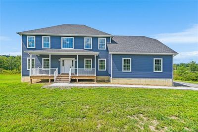 CUSTOM Colonial house featuring covered porch. | Image 1