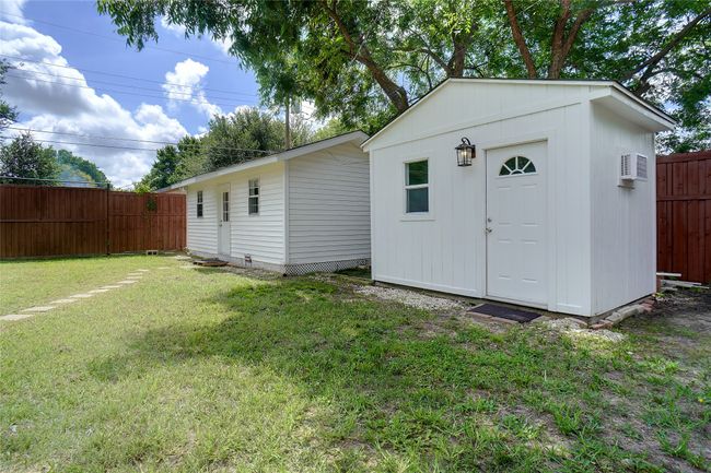 View of sheds with a fenced backyard and both with wall mounted AC units | Image 20