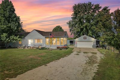 View of front of property with an outbuilding, a garage, and a lawn | Image 1