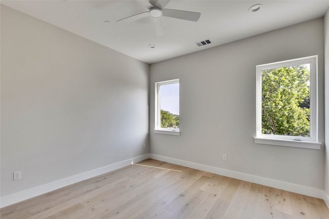 Unfurnished room featuring baseboards, a ceiling fan, light wood-style flooring, and recessed lighting | Image 27