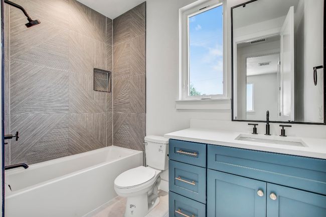 Full bath featuring vanity, toilet, and shower / tub combination | Image 25