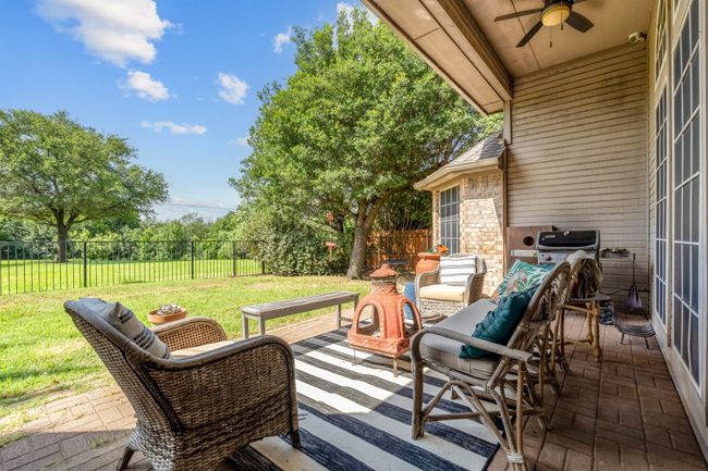 View of patio with a ceiling fan and an outdoor living space | Image 34