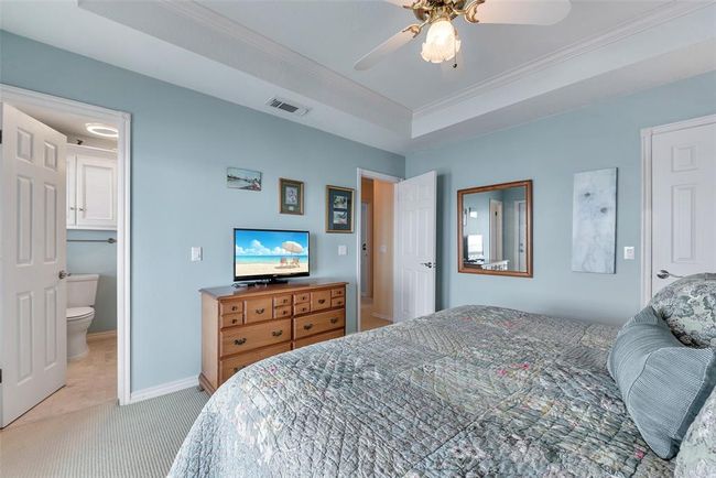 The spacious primary bedroom includes a full ensuite bath, offering both privacy and comfort. | Image 24