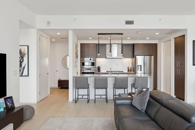 Living room with light wood-style flooring and recessed lighting | Image 16