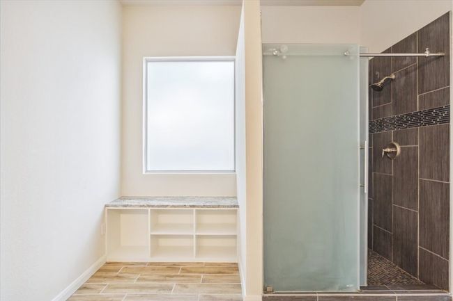 Full bath featuring a shower stall and wood finished floors | Image 21