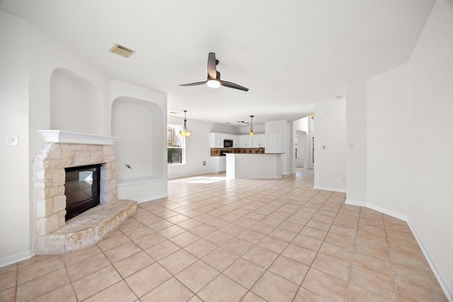 The family room, kitchen and dining have hard tile flooring | Image 8