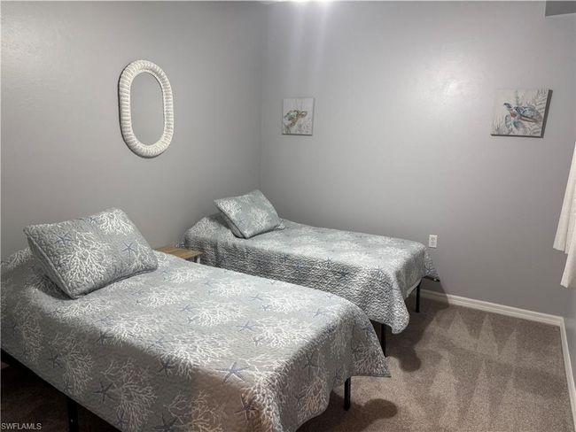 Carpeted bedroom featuring baseboards | Image 12