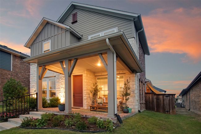 View of front of home featuring board and batten siding, a front yard, covered porch, and stone siding | Image 34