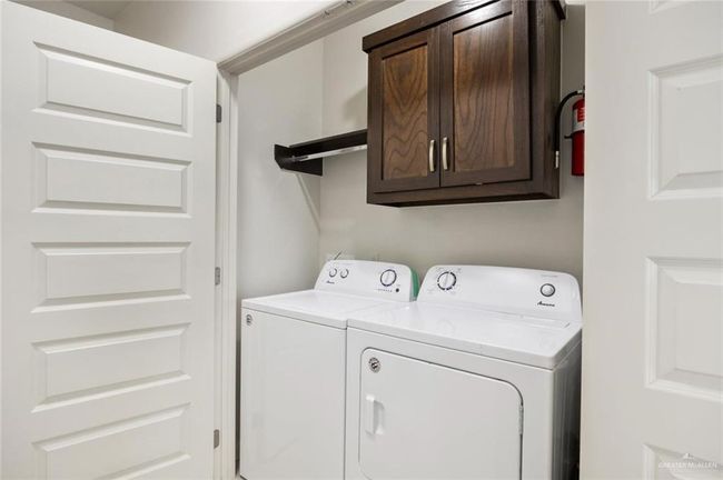 Washroom with cabinets and washing machine and dryer | Image 7