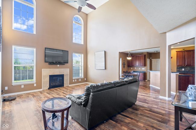 Two-story Great Room with an abundance of windows and a gas fireplace. Wonderful open floorplan is great for entertaining. | Image 15