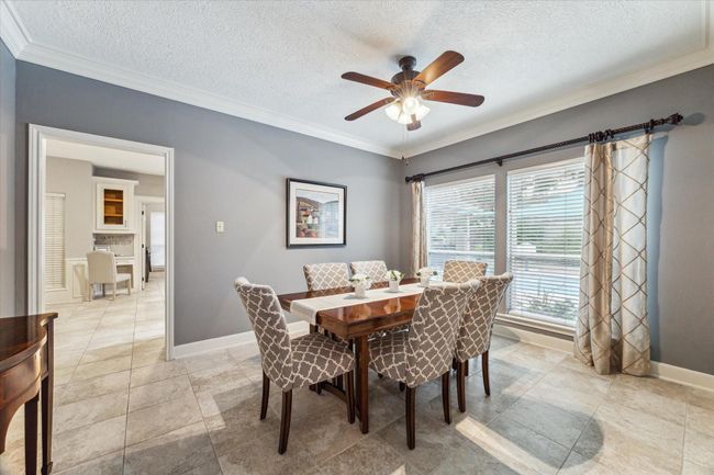 The dining room windows look out to the pool and garden. | Image 9