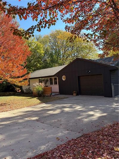 View of front of home featuring a garage and a front yard | Image 1