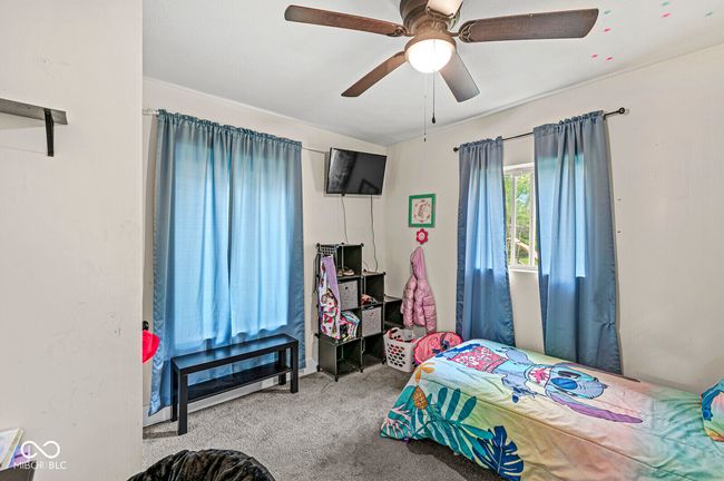 carpeted bedroom with ceiling fan | Image 15