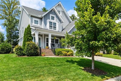 Craftsman-style home featuring a front yard and covered porch | Image 1